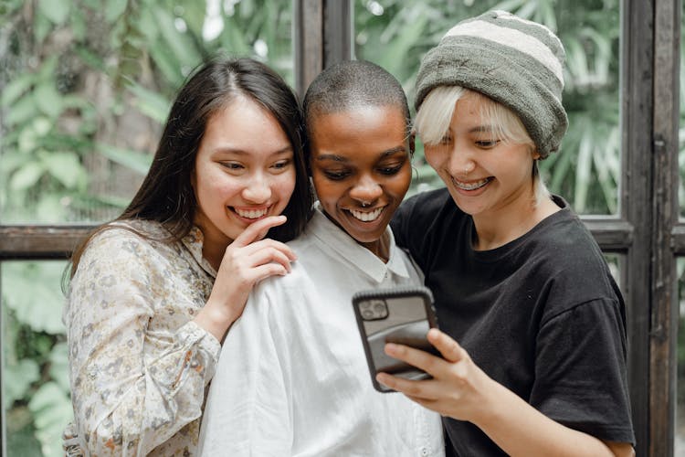 Happy Young Diverse Female Friends Taking Selfie On Mobile Phone