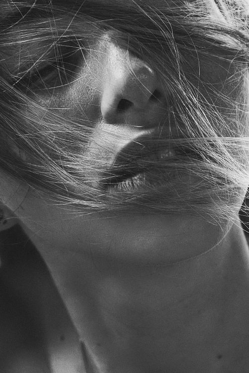 Free Captivating grayscale close-up portrait of a woman with windswept hair in Kyiv. Stock Photo