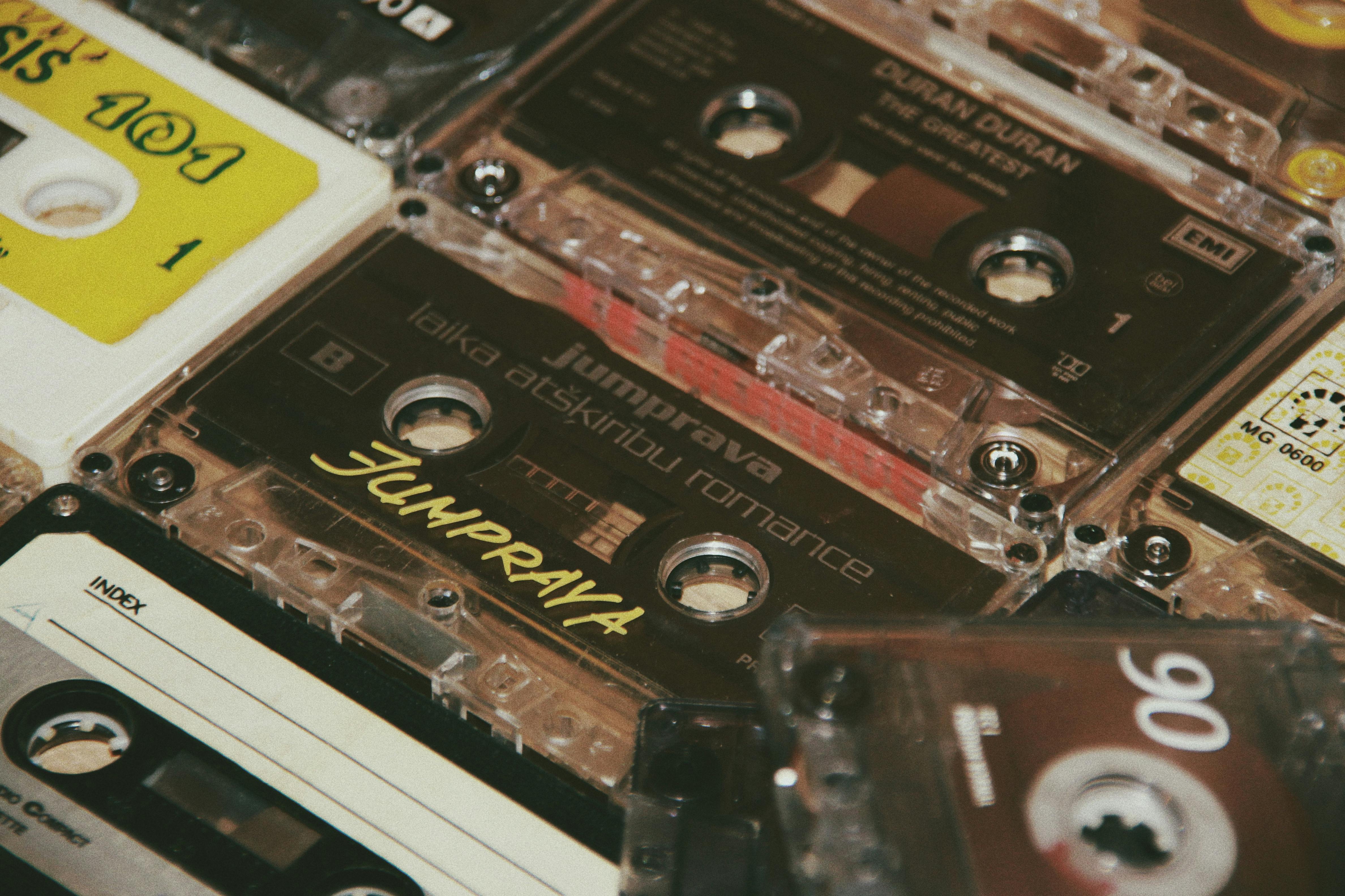 From above of different aged audio cassettes with inscriptions on plastic surface in flat
