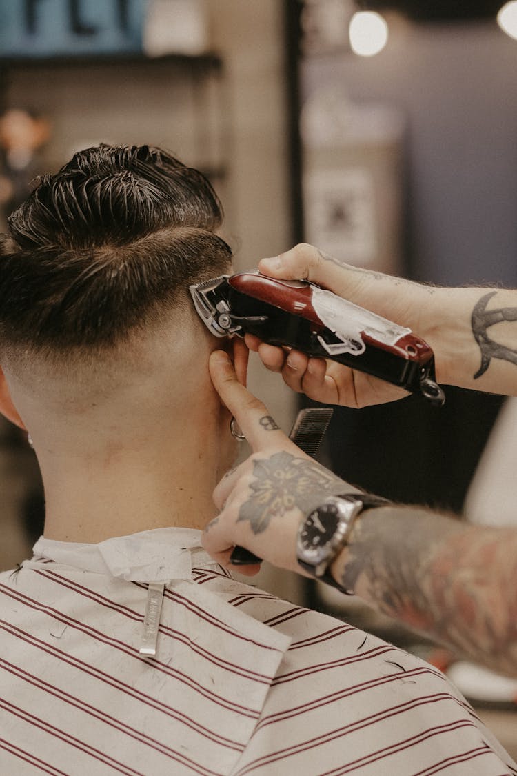 Person Shaving The Hair Of A Man