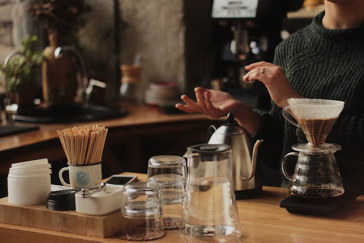 Barista Making Coffee In Cafe