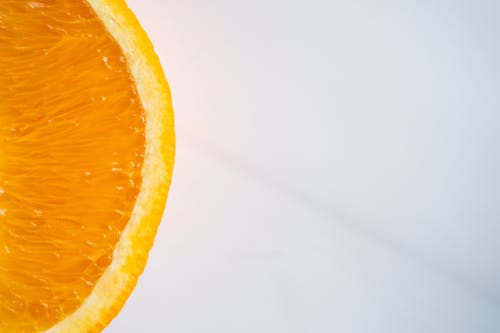 Free From above of cut juicy orange with bright tender pulp and thick peel on table Stock Photo