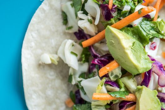 Bright delicious vegetable vitamin salad on tortilla