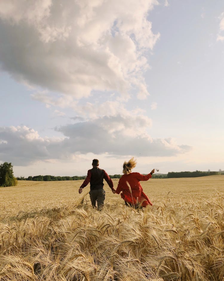 Man And Woman Running On Field