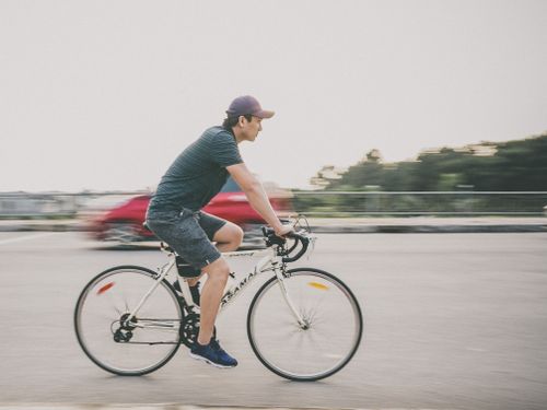 Free Asian man cycling quickly along a road in Vĩnh Yên, Vietnam. Stock Photo