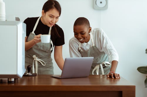 Free Happy cafe colleagues surfing laptop in kitchen Stock Photo