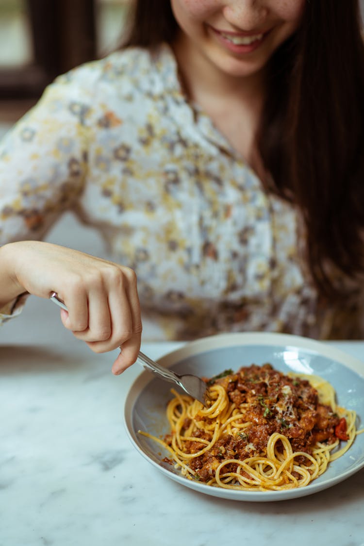 Crop Cheerful Woman Eating Pasta In Cafe