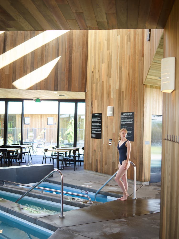 Slim Woman In Swimsuit Entering Spa Pool