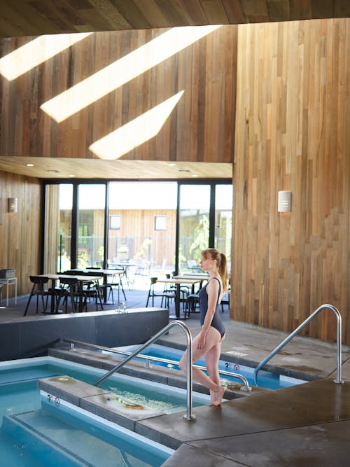 Photo of Woman in Black Bikini Standing on Poolside