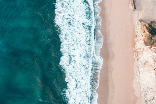 Aerial View of Sea Waves on Seashore