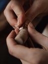 Person Wearing Gold Ring With Diamond