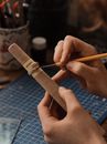 Person Holding Brown Wooden Stick