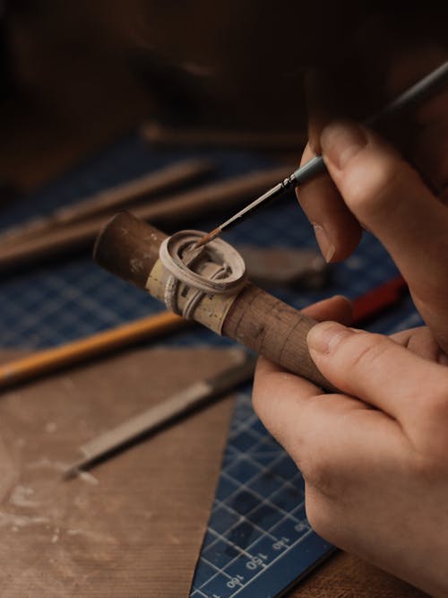 Person Holding Brown and Silver Smoking Pipe