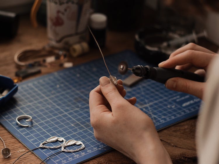 Hands Of A Person Polishing A Silver Object