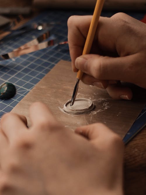 Person Holding Yellow and Silver Cutter 