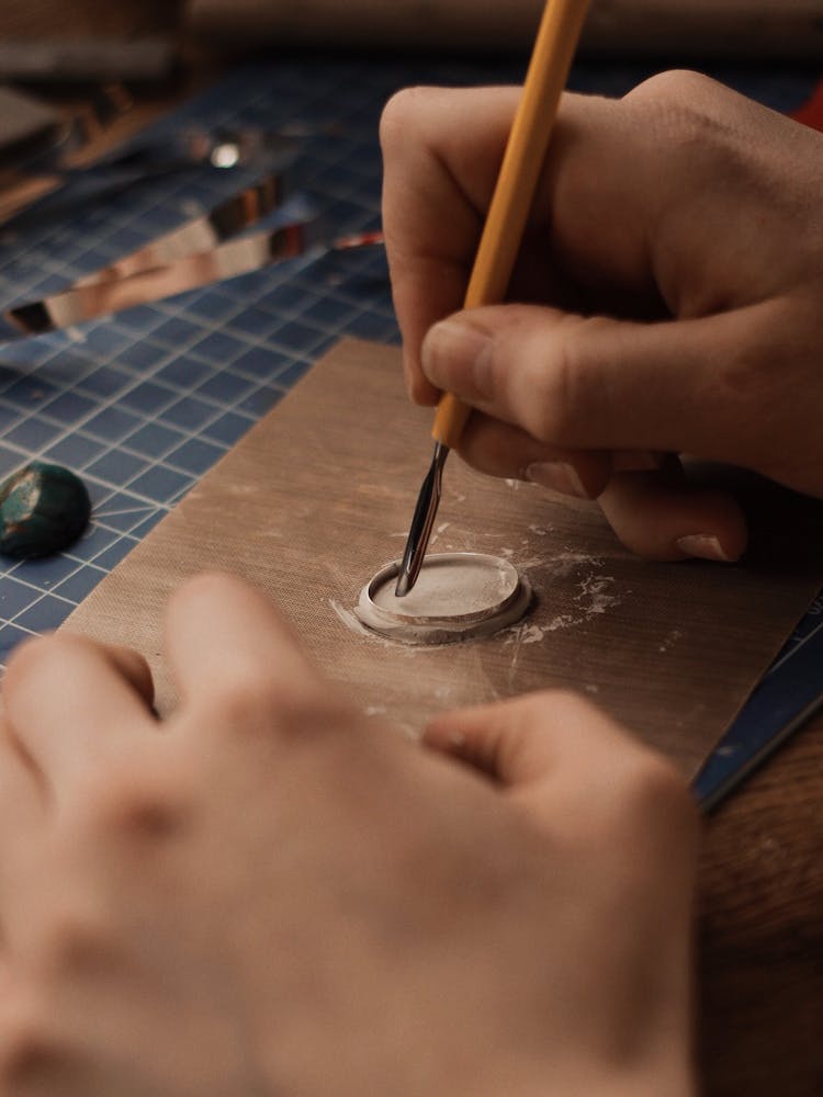 Person Holding Yellow And Silver Cutter 