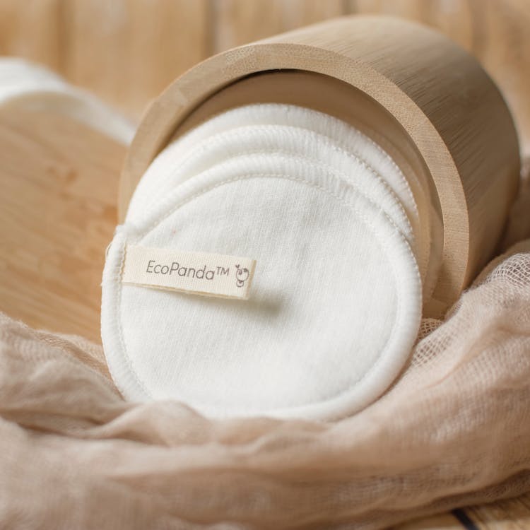 White Fabric Pads In A Bamboo Container