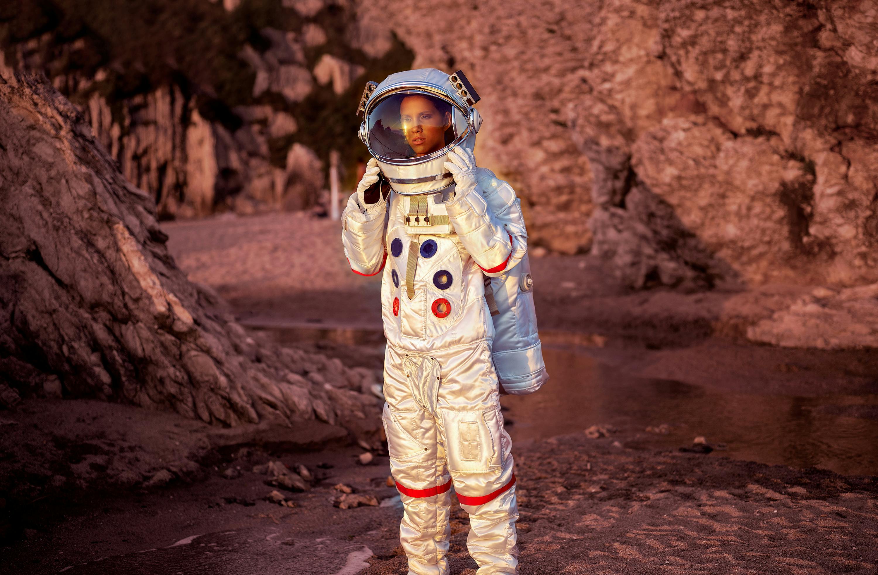 astronaut standing behind girl