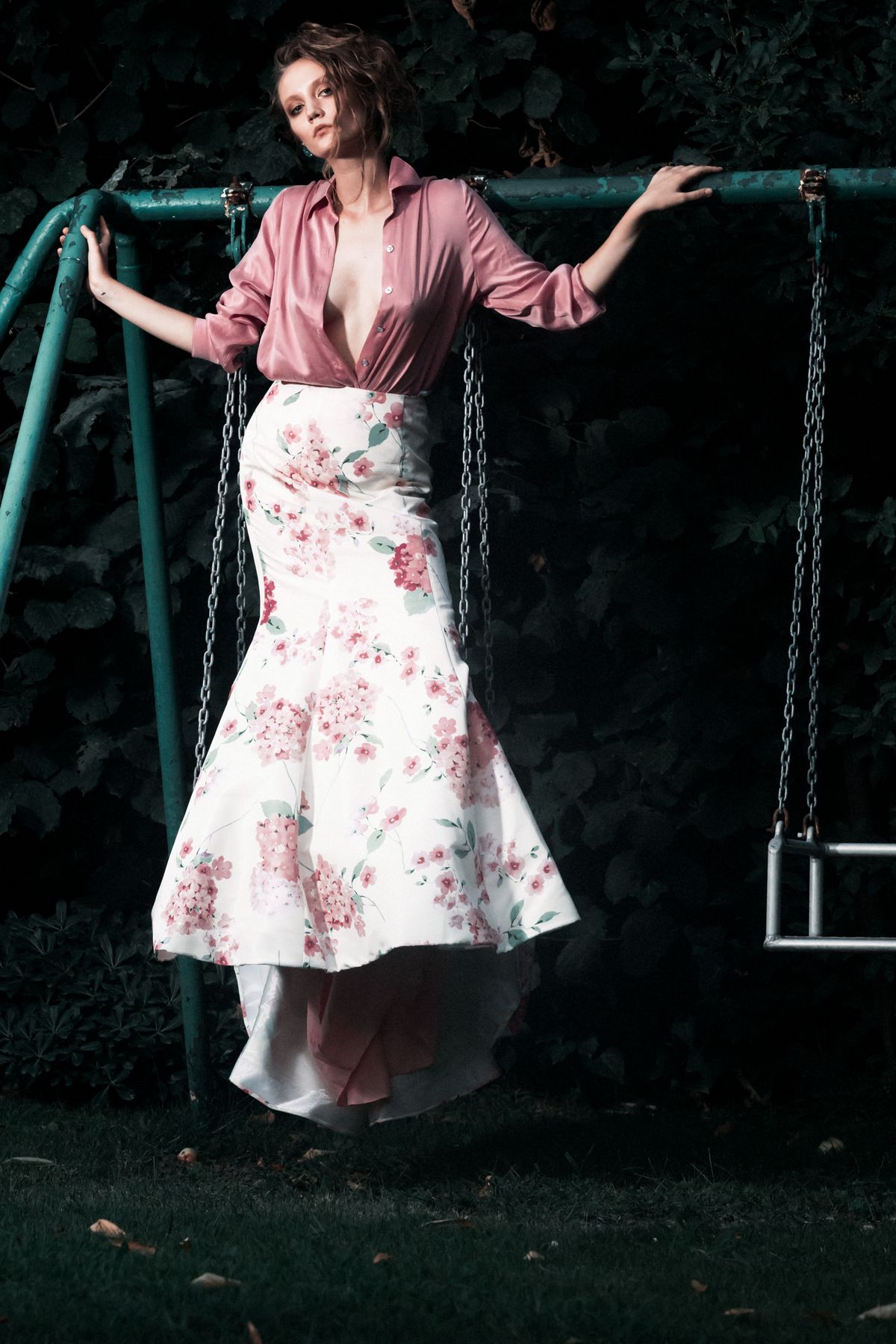 A woman in an elegant gown on a garden swing — the romance of the garden party