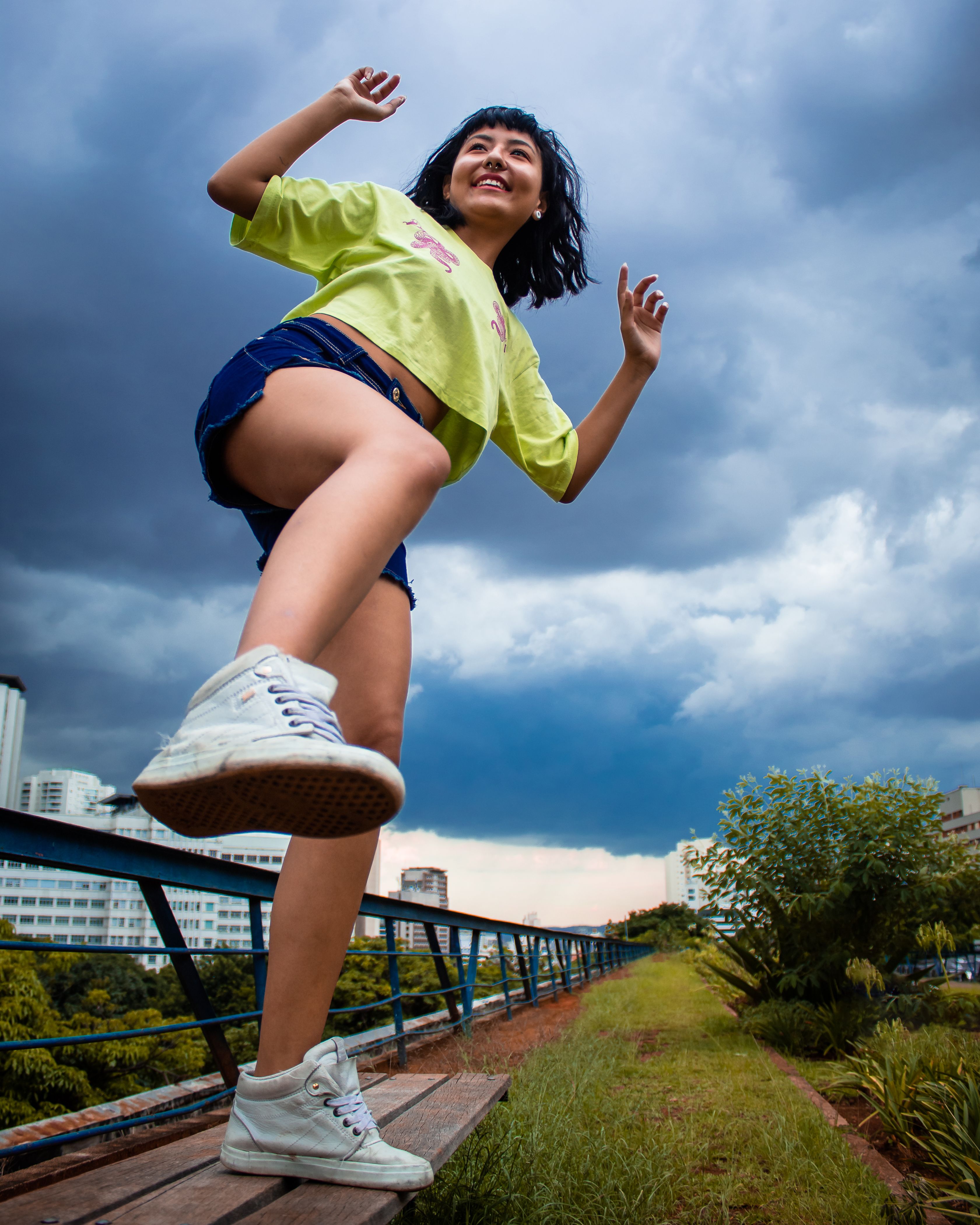 Stylish ethnic woman walking fast on footpath in park · Free Stock Photo
