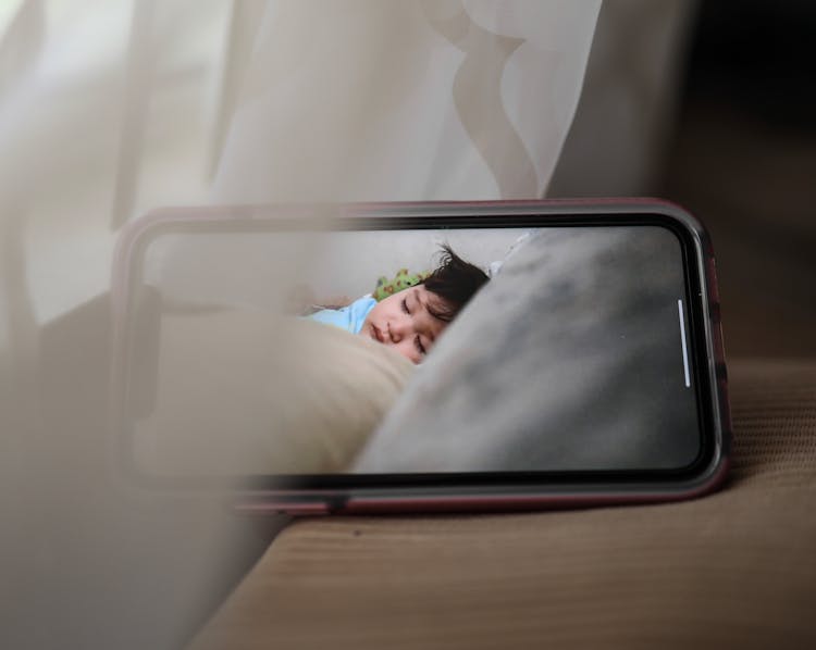 Screen Of Mobile Phone With Sleeping Baby