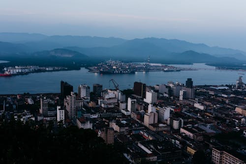 Cityscape of coastal city against misty hills