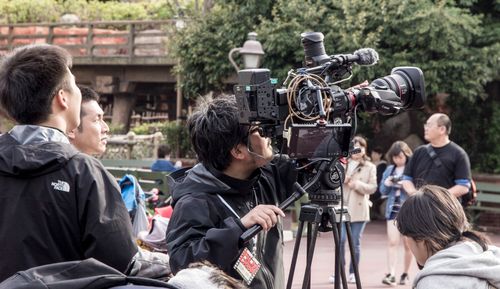 Free Film crew working with advanced camera equipment outdoors. Capturing footage in natural daylight. Stock Photo
