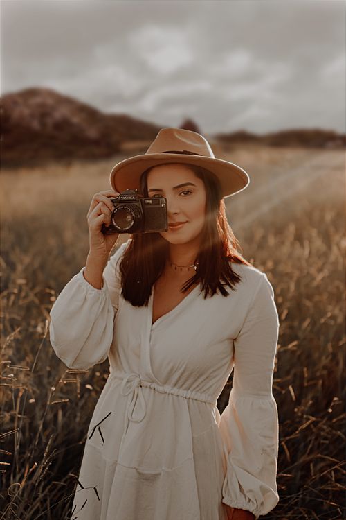 A Woman in a White Dress Holding a Camera Free Stock Photo A Woman in a White Dress Holding a Camera Free Stock Photo