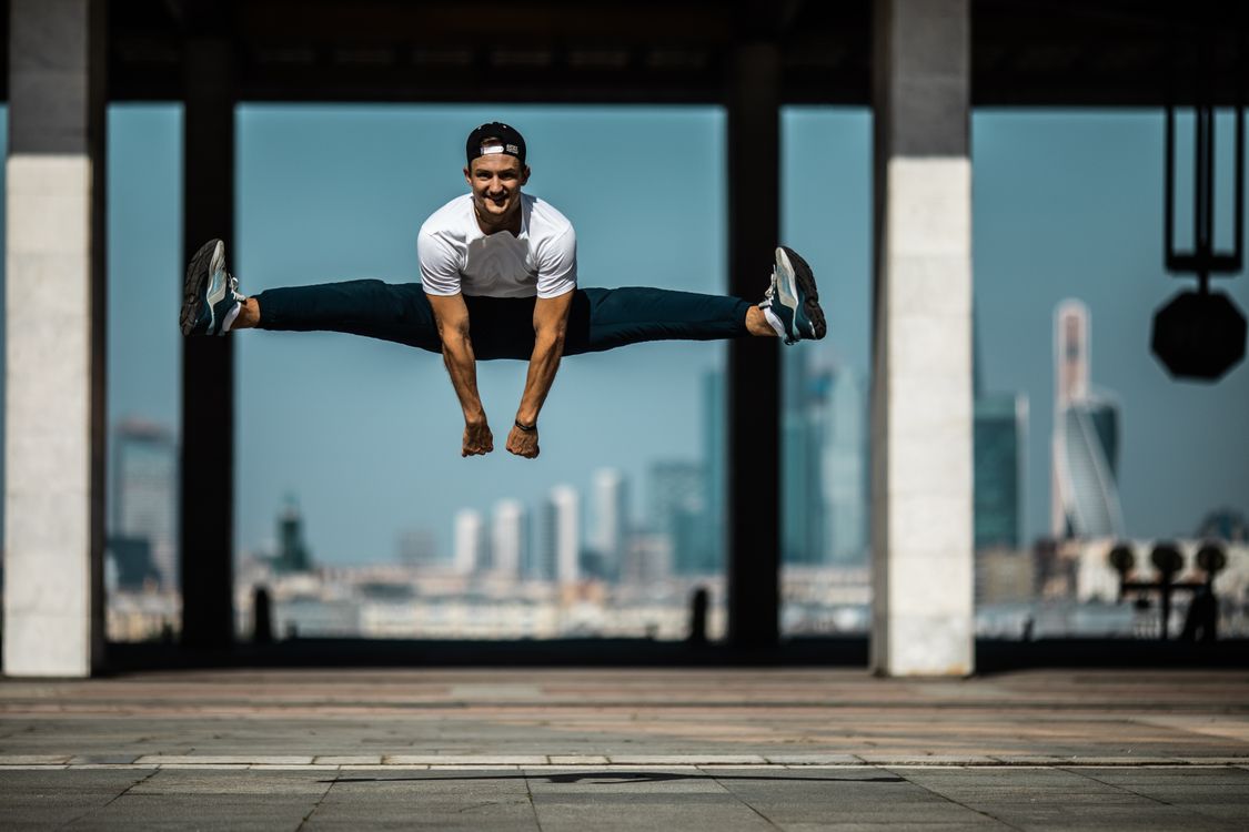 Dynamic Leg Split A Man Doing a Leg Split in Mid Air · Free Stock Photo