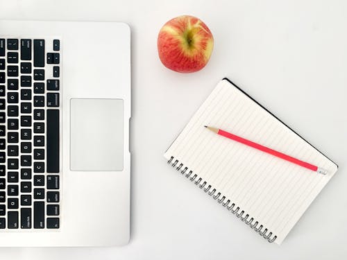 Free Workplace with notebook and laptop near apple Stock Photo