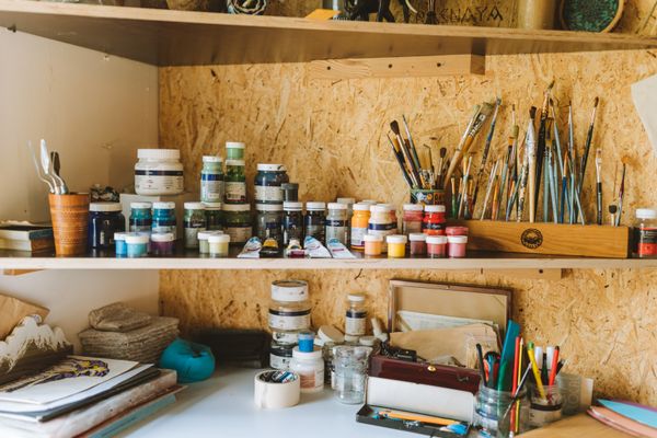 Artist workspace with paints and brushes — photo by Yaroslav Shuraev on Pexels