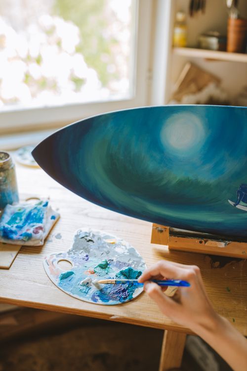 Free Hand crafting a unique painting in a cozy home studio, highlighting artistic creativity. Stock Photo
