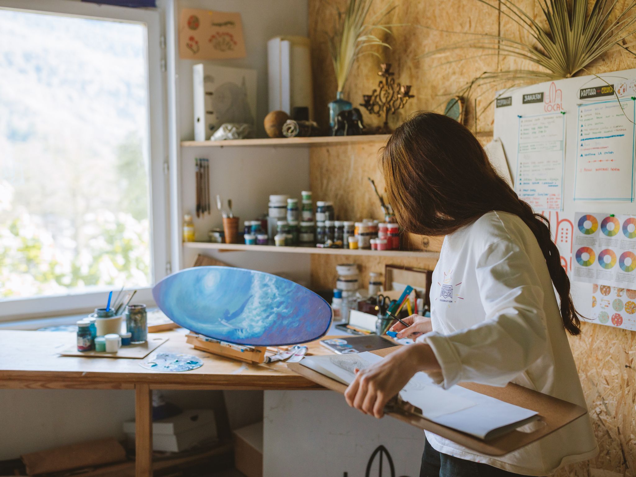 Artist working on a painting in a studio