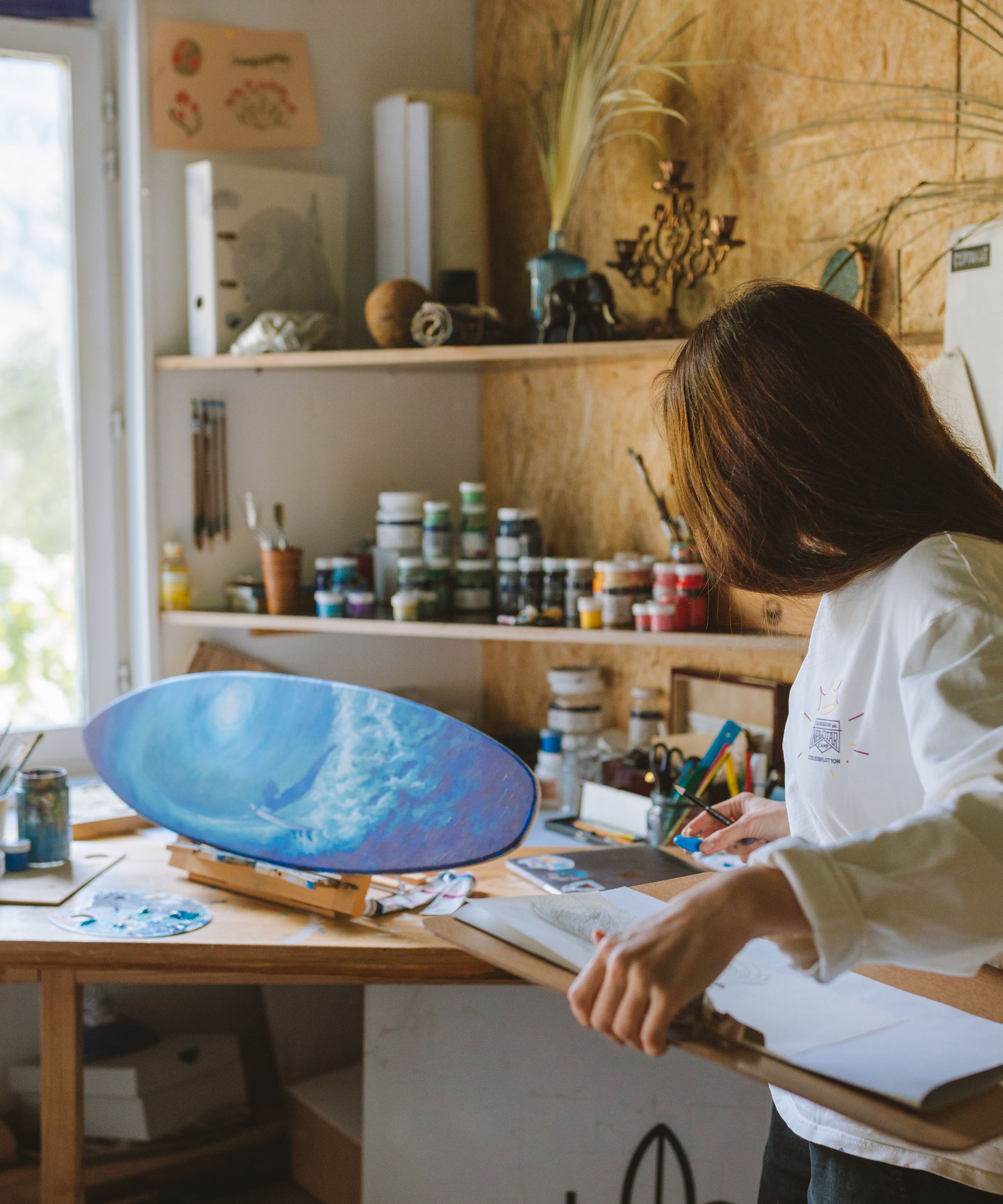 Artist working on a painting in a studio