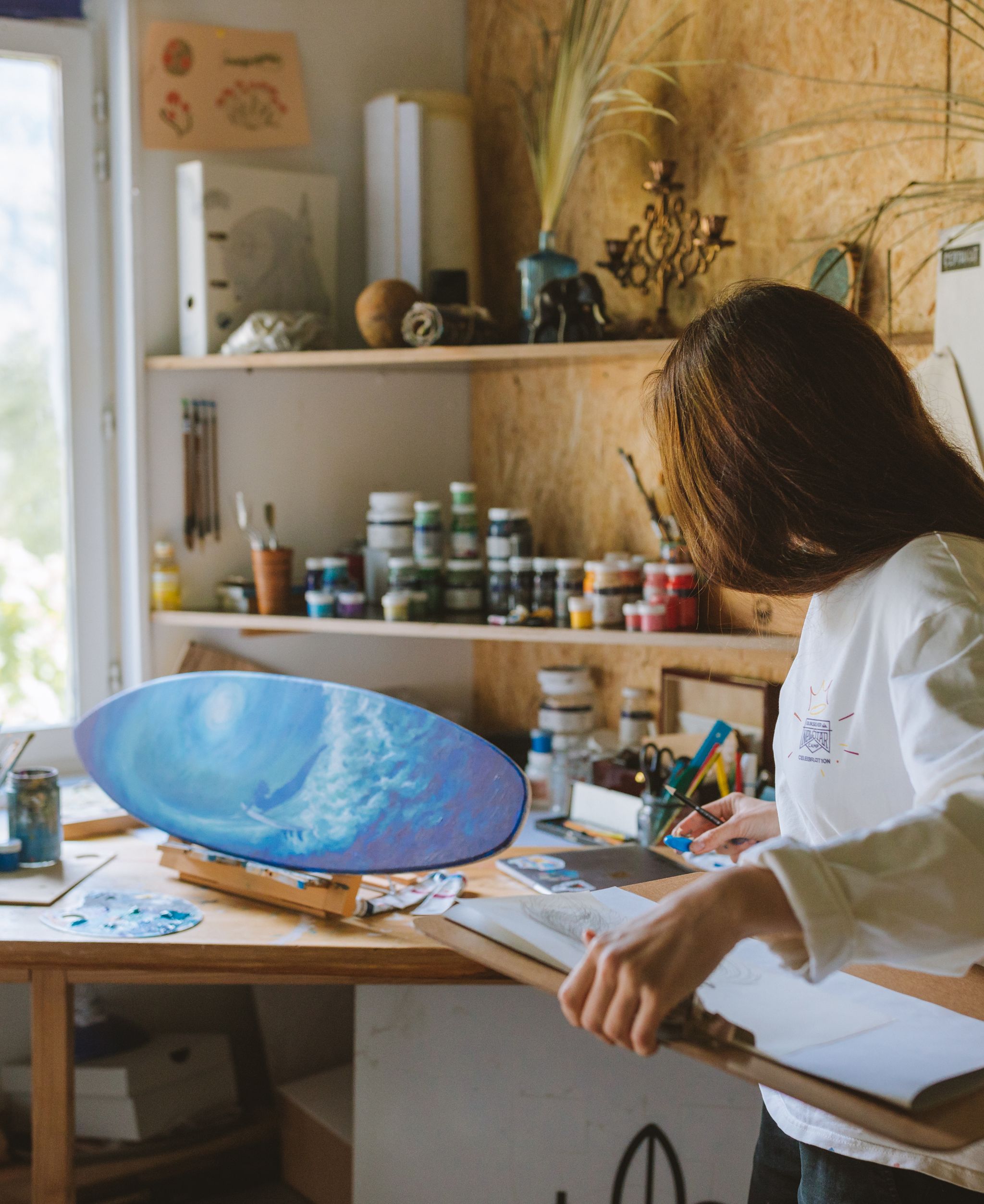 Artist working on a painting in a studio