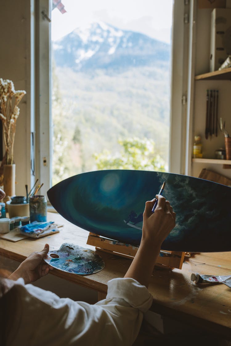 A Painter Painting A Surfboard