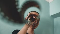 Woman in Black Shirt Holding Her Head