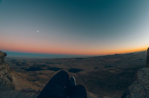 Free Experience the breathtaking view of a colorful sunset over the Mitzpe Ramon crater in Israel. Stock Photo