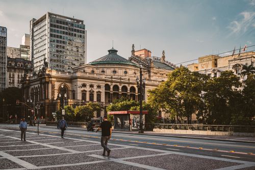Free Full body of unrecognizable pedestrians walking on city square near modern buildings and historical Theatro Municipal located in Sao Paulo Stock Photo