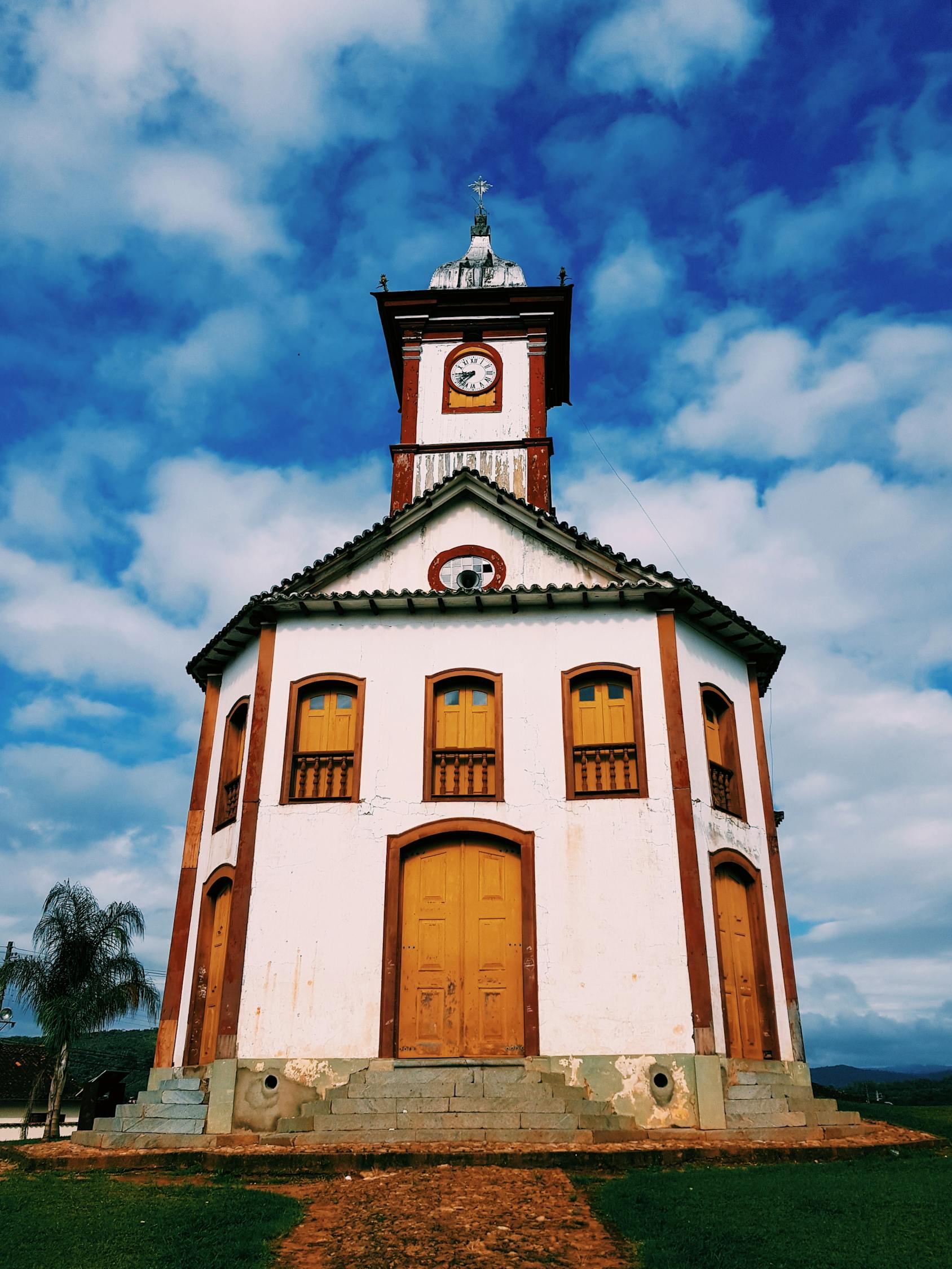 Ancient chapel with tower against cloudy sky · Free Stock Photo