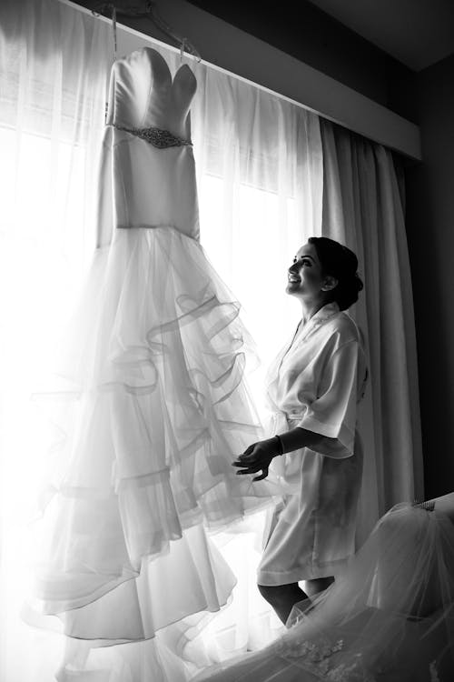 Free Woman in White Robe Standing beside White Curtain Stock Photo
