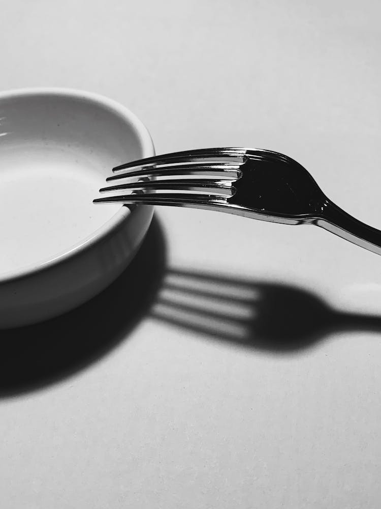 Silver Fork Placed On White Plate