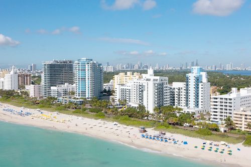 Free Stunning aerial shot of Miami Beach skyline with bright blue skies and sandy coastlines. Stock Photo