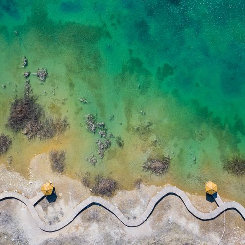 Free Stunning aerial shot showcasing the coastline and winding pathway in Jaworzno, Poland. Stock Photo