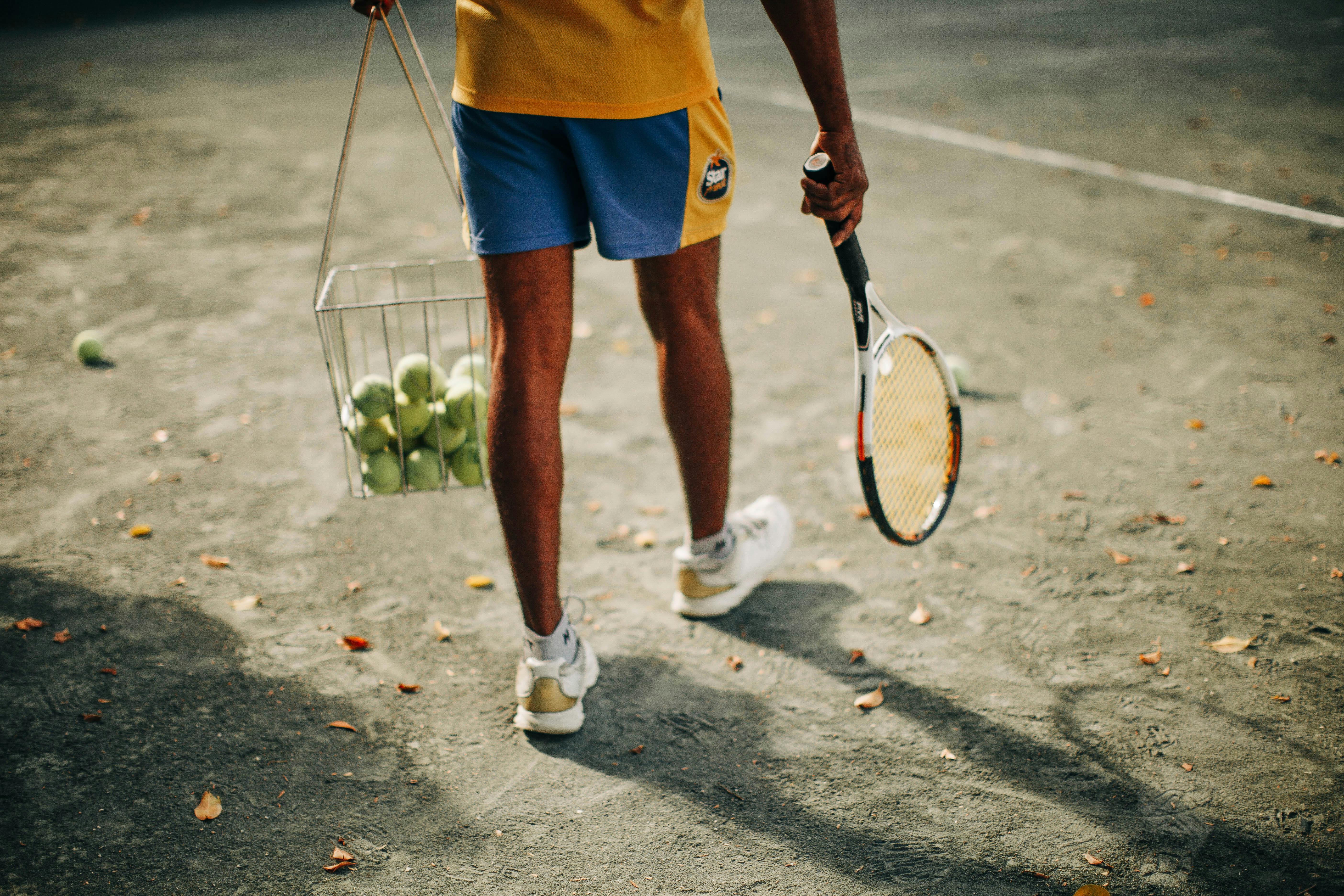 Professional tennis player wearing sports clothes holding racket and tennis  ball stock photo