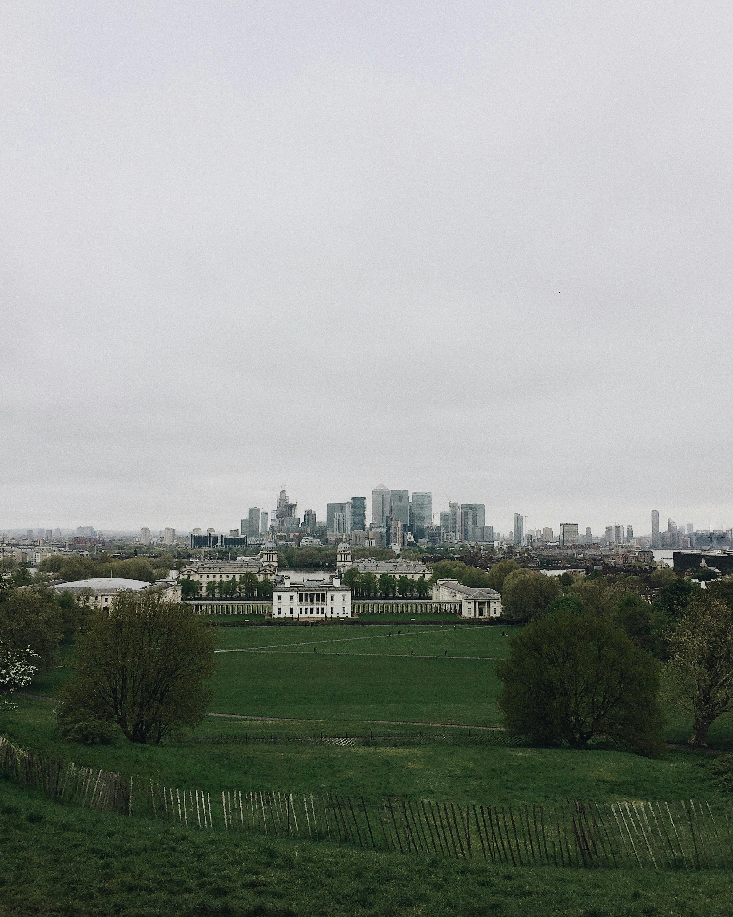 Overcast view of Greenwich Park with Canary Wharf skyline in the background, London.
