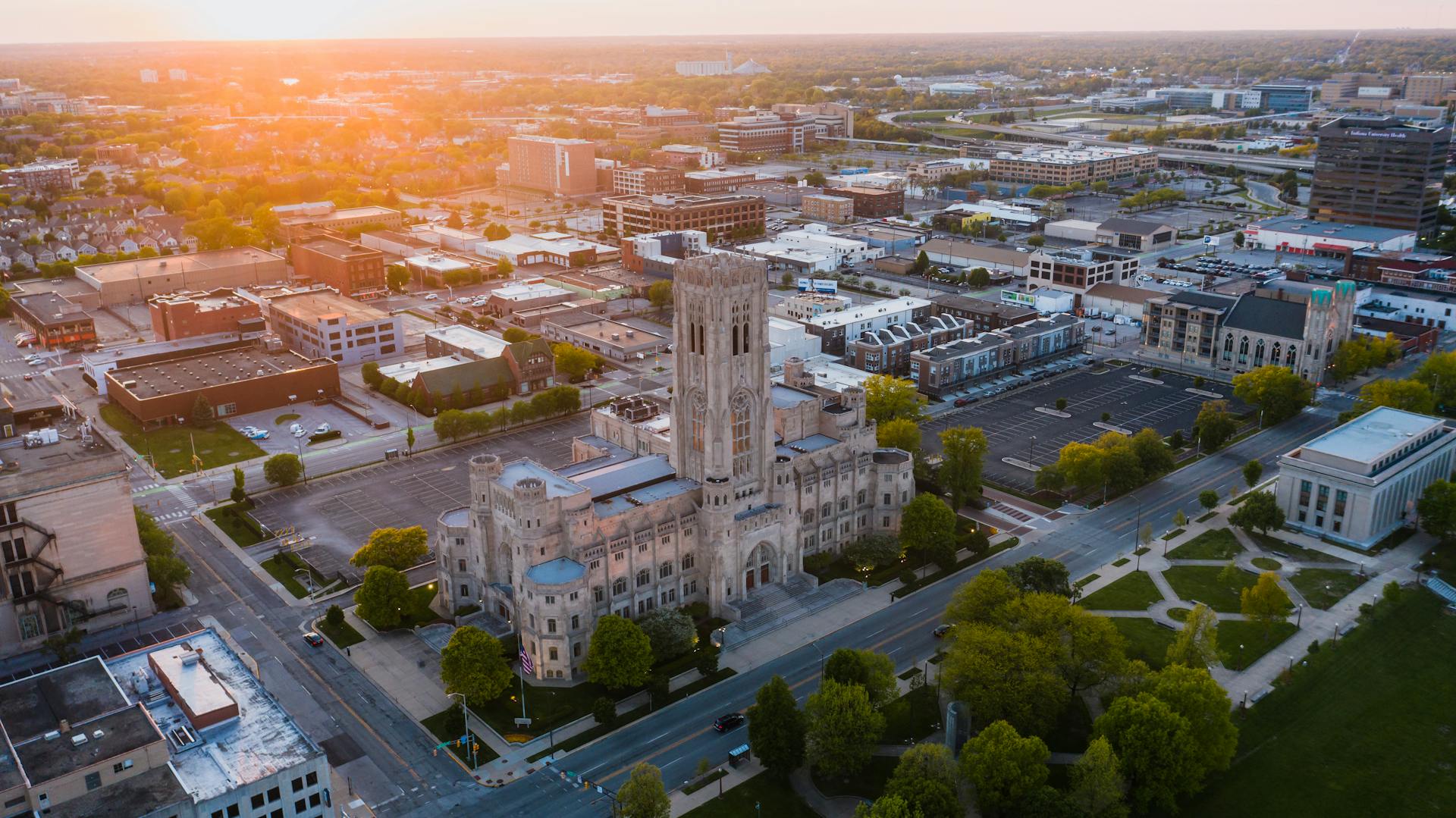 Aerial view of a historic building in downtown Indianapolis at sunset, showcasing urban architecture.