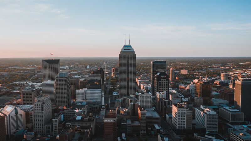 A breathtaking aerial view of the Indianapolis skyline at dusk, showcasing urban architecture.