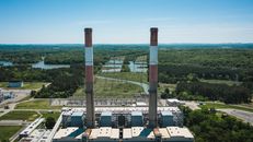 Industrial chimneys on power plant platform under sky