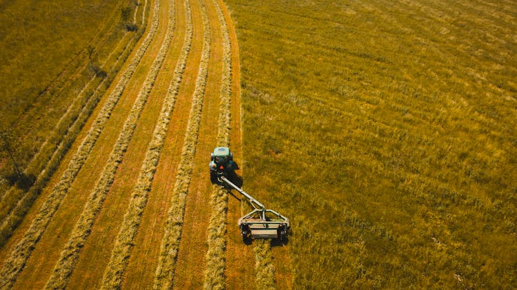 Aerial Photo Of Tractor Landscape Rake On Grass Field